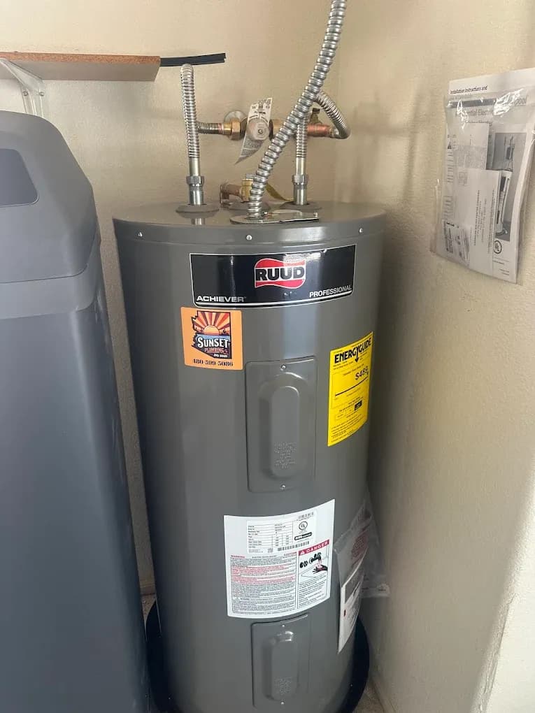 RUUD water heater with a Sunset Plumbing sticker beside a water softener in a Gilbert home
